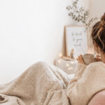 Gemütliche Selbstfürsorge während der Menstruation mit Tee und Decke, Ernährung während der Periode und weiblicher Zyklus im Alltag